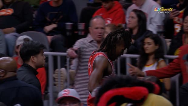 Chicago Bulls guard Ayo Dosunmu heads to the locker room after suffering an injury during a collision with Trae Young of the Atlanta Hawks