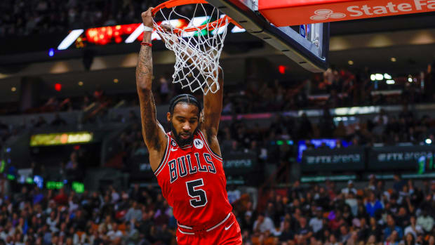 Dec 20, 2022; Miami, Florida, USA; Chicago Bulls forward Derrick Jones Jr. (5) hangs from the rim after dunking the basketball during the second quarter against the Miami Heat at FTX Arena.