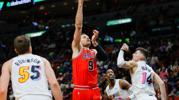 Dec 20, 2022; Miami, Florida, USA; Chicago Bulls center Nikola Vucevic (9) shoots the basketball over Miami Heat guard Tyler Herro (14) during the second quarter at FTX Arena.