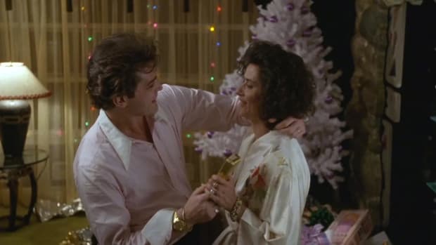 Henry Hill gives Karen Christmas gifts in front of the tree in GoodFellas