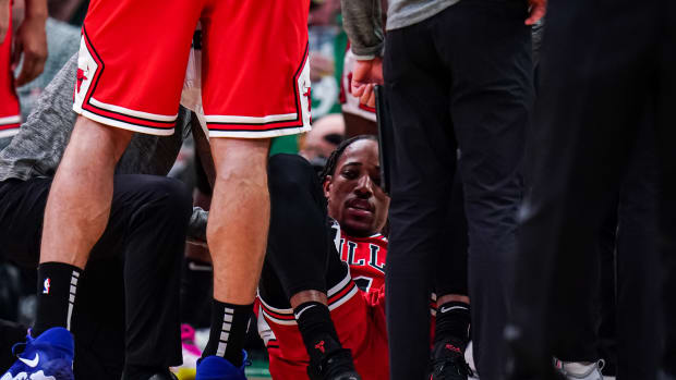 Jan 9, 2023; Boston, Massachusetts, USA; Chicago Bulls forward DeMar DeRozan (11) is helped up after falling to the ground against the Boston Celtics at TD Garden. Mandatory Credit: David Butler II-USA TODAY Sports