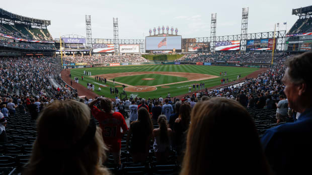 Jul 4, 2022; Chicago, Illinois, USA; Players from the Chicago White Sox and the Minnesota Twins and fans observe a moment of silence to honor the shooting victims from the shooting in Highland Park, Illinois before the game at Guaranteed Rate Field.