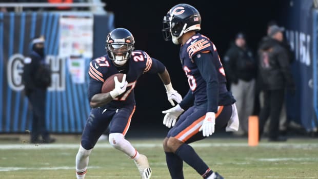 Jan 8, 2023; Chicago, Illinois, USA; Chicago Bears cornerback Greg Stroman Jr. (27) runs with the ball after making an interception against the Minnesota Vikings during the second half at Soldier Field.