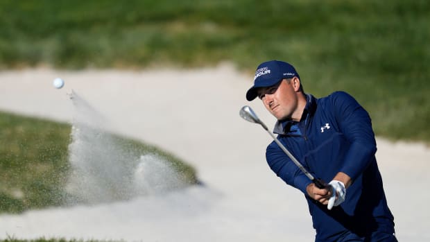 Feb 6, 2022; Pebble Beach, California, USA; Jordan Spieth plays his shot from the 17th bunker during the final round of the AT&T Pebble Beach Pro-Am golf tournament at Pebble Beach Golf Links.