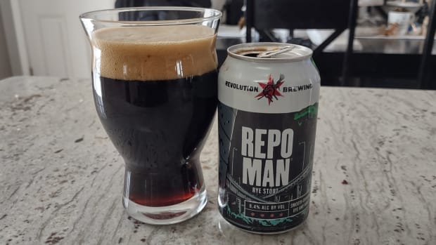 A Revolution Brewing Repo Man can with the beer poured into a glass next to it
