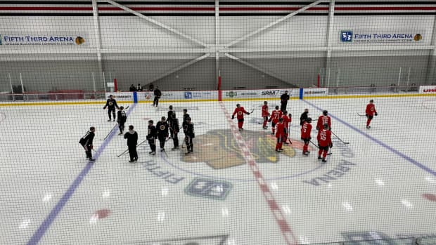 Chicago Blackhawks players gather on the ice at training camp