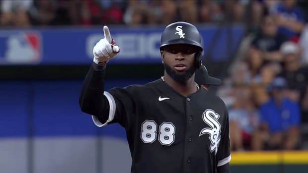 Chicago White Sox outfielder Luis Robert points to the dugout from second base