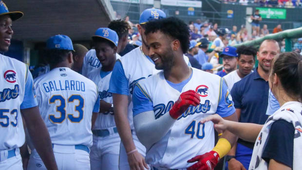 Chicago Cubs prospect Josue Huma celebrates with teammates in the Myrtle Beach Pelicans dugout