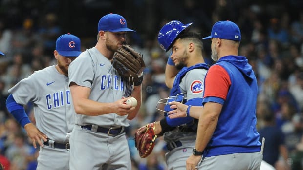 Aug 27, 2022; Milwaukee, Wisconsin, USA; Chicago Cubs relief pitcher Rowan Wick (50) is taken out of the game by Chicago Cubs manager David Ross (3) in the seventh inning against the Milwaukee Brewers at American Family Field.