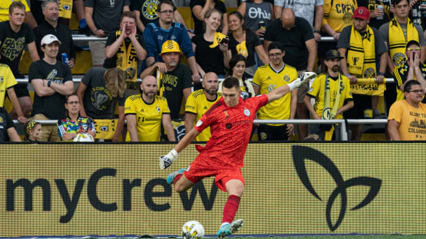 Chicago Fire FC goalkeeper Gabriel Slonina kicks the ball as Columbus Crew fans look on