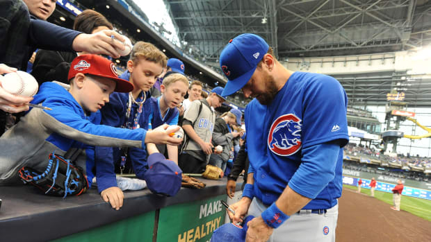 Apr 7, 2019; Milwaukee, WI, USA; Chicago Cubs outfielder Ben Zobrist (18) signs autographs prior to their game at Miller Park.