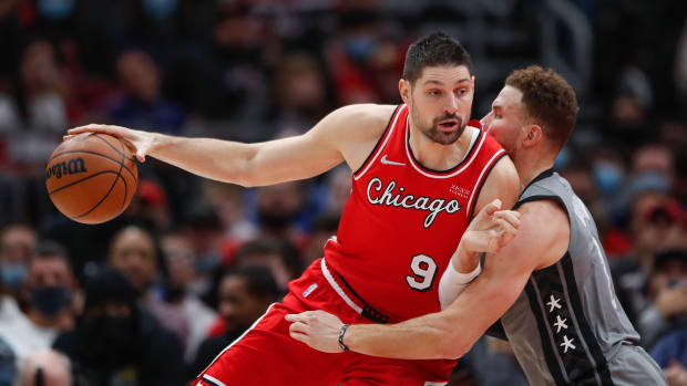 Jan 12, 2022; Chicago, Illinois, USA; Chicago Bulls center Nikola Vucevic (9) dribbles the ball while defended by Brooklyn Nets forward Blake Griffin (2) during the second half at United Center.