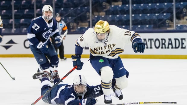 Mar 14, 2021; South Bend, Indiana, USA; Notre Dame s Landon Slaggert (19) gets past Penn State's Bobby Hampton (12) at the Compton Family Ice Arena.