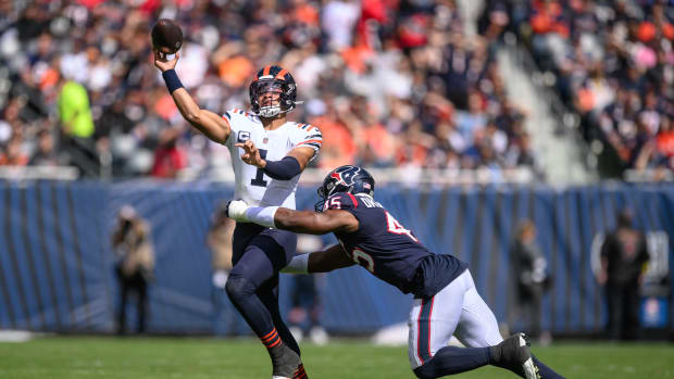 Sep 25, 2022; Chicago, Illinois, USA; Chicago Bears quarterback Justin Fields (1) passes the ball as Houston Texans defensive end Obo Okoronkwo (45) pressures in the first quarter at Soldier Field.