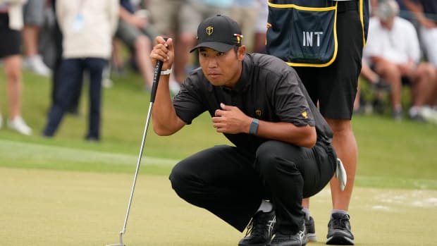 Sep 25, 2022; Charlotte, North Carolina, USA; International Team golfer Hideki Matsuyama lines up his putt on the first green during the singles match play of the Presidents Cup golf tournament at Quail Hollow Club.