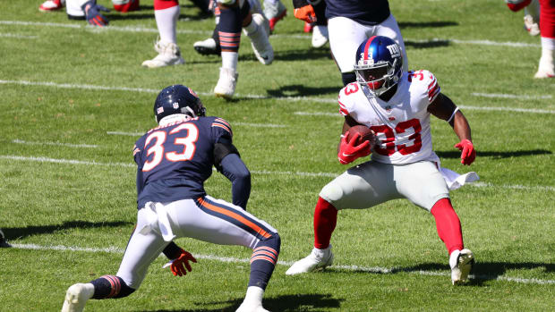 Sep 20, 2020; Chicago, Illinois, USA; New York Giants running back Dion Lewis (33) rushes the ball against Chicago Bears cornerback Jaylon Johnson (33) during the second quarter at Soldier Field.