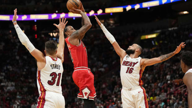 Oct 19, 2022; Miami, Florida, USA; Chicago Bulls forward DeMar DeRozan (11) goes up for a shot over Miami Heat forward Caleb Martin (16) as guard Max Strus (31) looks on in the first half at FTX Arena.