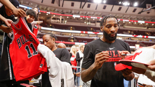 Oct 4, 2022; Chicago, Illinois, USA; Chicago Bulls center Andre Drummond (3) and forward DeMar DeRozan (11) sign autographs before a preseason NBA basketball game against the New Orleans Pelicans at United Center.