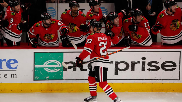 Oct 25, 2022; Chicago, Illinois, USA; Chicago Blackhawks forwars Philipp Kurashev celebrates with teammates near the bench after scoring a goal against the Florida Panthers during the second period at United Center.
