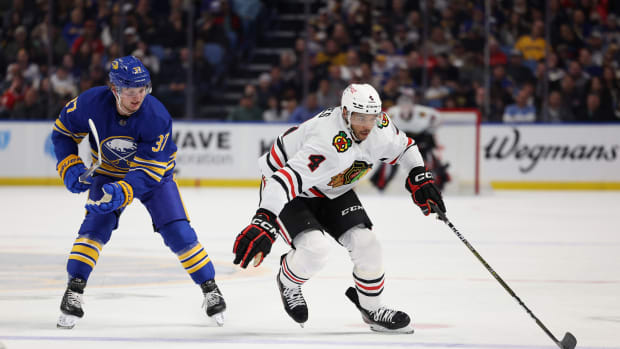 Oct 29, 2022; Buffalo, New York, USA; Chicago Blackhawks defenseman Seth Jones (4) carries the puck up ice while Buffalo Sabres center Casey Mittelstadt (37) defends during the first period at KeyBank Center.