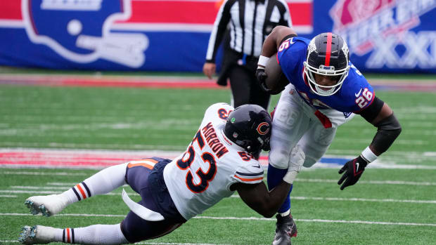 Oct 2, 2022; East Rutherford, New Jersey, USA; New York Giants running back Saquon Barkley (26) is tackled by Chicago Bears linebacker Nicholas Morrow (53) during the first half at MetLife Stadium.