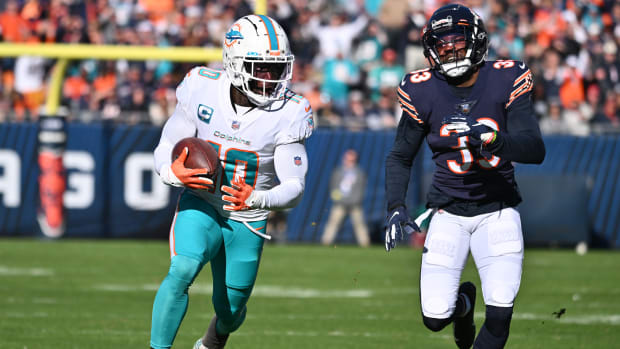 Nov 6, 2022; Chicago, Illinois, USA; Miami Dolphins wide receiver Tyreek Hill (10) runs after the catch as Chicago Bears defensive back Jaylon Johnson (33) gives chase in the second quarter at Soldier Field.