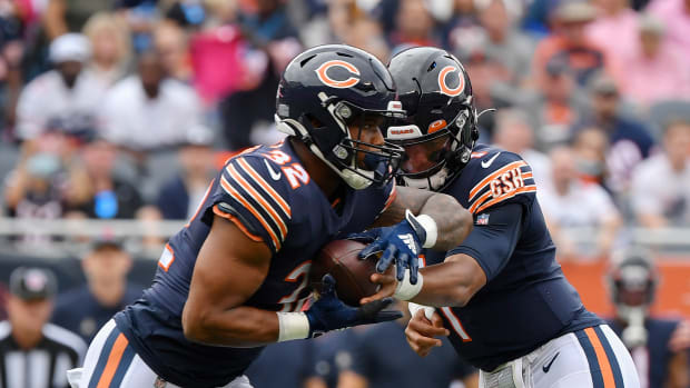 Oct 3, 2021; Chicago, Illinois, USA; Chicago Bears quarterback Justin Fields (1) hands the ball off to Chicago Bears running back David Montgomery (32) in the first half against the Detroit Lions at Soldier Field.
