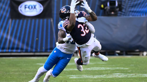 Nov 13, 2022; Chicago, Illinois, USA; Chicago Bears running back David Montgomery (32) is unable to hold onto a pass while being defended by Detroit Lions linebacker Chris Board (49) during the second half at Soldier Field.