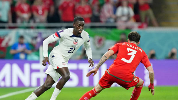Nov 21, 2022; Al Rayyan, Qatar; United States of America forward Timothy Weah (21) dribbles the ball against against Wales defender Neco Williams (3) during the second half during a group stage match during the 2022 FIFA World Cup at Ahmed Bin Ali Stadium.