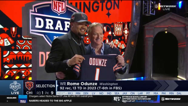 Wide receiver Rome Odunze poses for a picture on stage with NFL commissioner Roger Goodell after being selected ninth overall by the Chicago Bears in the 2024 NFL Draft.