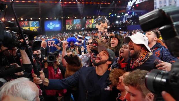Apr 25, 2024; Detroit, MI, USA; Southern California Trojans quarterback Caleb Williams poses with fans after being selected by the Chicago Bears as the No. 1 pick in the first round of the 2024 NFL Draft at Campus Martius Park and Hart Plaza.