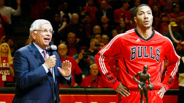 May 4, 2011; Chicago, IL, USA; NBA commissioner David Stern (left) presents the MVP trophy to Chicago Bulls point guard Derrick Rose (right) before game two of the second round of the 2011 NBA playoffs against the Atlanta Hawks at the United Center.