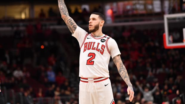 Feb 28, 2025; Chicago, Illinois, USA; Chicago Bulls forward Lonzo Ball (2) hits a three-point shot against Toronto Raptors guard Jamal Shead (23) during overtime at the United Center.