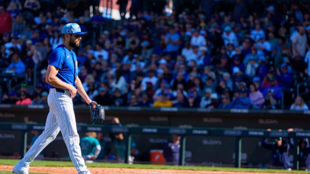 Mar 8, 2025; Mesa, Arizona, USA; Chicago Cubs pitcher Julian Merryweather (66) reacts after pitching in the seventh inning of the spring training game against the Seattle Mariners at Sloan Park.