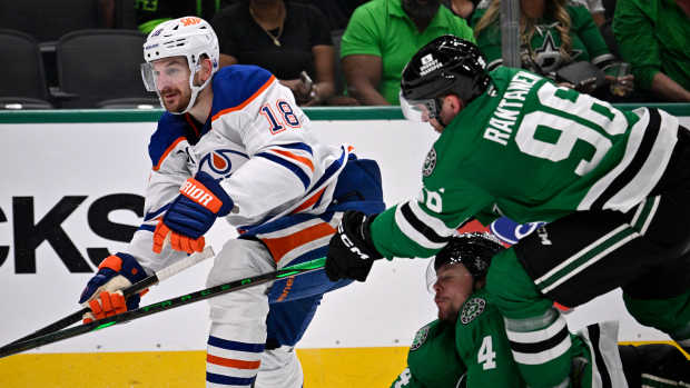May 23, 2025; Dallas, Texas, USA; Dallas Stars right wing Mikko Rantanen (96) slashes Edmonton Oilers left wing Zach Hyman (18) in the third period for game two of the Western Conference Final of the 2025 Stanley Cup Playoffs at American Airlines Center.