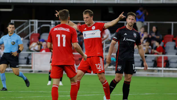 Jun 7, 2025; Washington, District of Columbia, USA; Chicago Fire forward Tom Barlow (12) celebrates with Fire forward Philip Zinckernagel (11) after scoring a goal against the D.C. United during the first half at Audi Field. Mandatory Credit: Amber Searls-Imagn Images