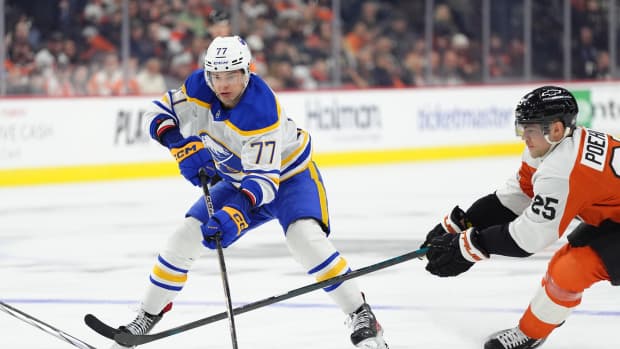 Mar 29, 2025; Philadelphia, Pennsylvania, USA; Buffalo Sabres right wing JJ Peterka (77) controls the puck against Philadelphia Flyers center Ryan Poehling (25) in the third period at Wells Fargo Center.
