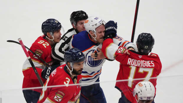 Jun 9, 2025; Sunrise, Florida, USA; Florida Panthers forward Evan Rodrigues (17) fights Edmonton Oilers right wing Corey Perry (90) during the third period in game three of the 2025 Stanley Cup Final at Amerant Bank Arena.