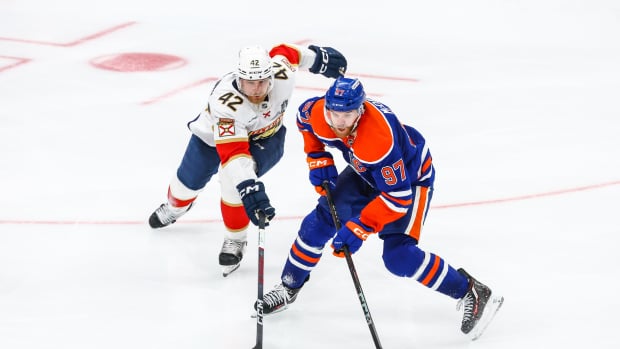Jun 14, 2025; Edmonton, Alberta, CAN; Edmonton Oilers center Connor McDavid (97) controls the puck against Florida Panthers defenseman Gustav Forsling (42) during the third period in game five of the 2025 Stanley Cup Final at Rogers Place.