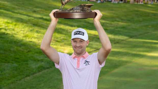 Jul 6, 2025; Silvis, Illinois, USA; 2025 Tournament champion Brian Campbell holds up the trophy after the final round of the John Deere Classic golf tournament.