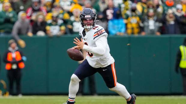 Jan 5, 2025; Green Bay, Wisconsin, USA; Chicago Bears quarterback Caleb Williams rushes with the football during the second quarter against the Green Bay Packers at Lambeau Field. Mandatory Credit: Jeff Hanisch-Imagn Images