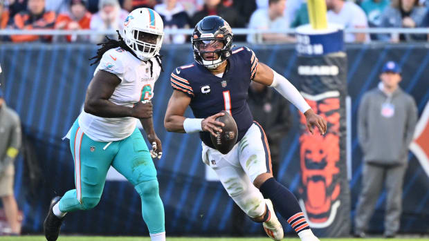 Nov 6, 2022; Chicago, Illinois, USA; Chicago Bears quarterback Justin Fields (1) runs upfield past Miami Dolphins linebacker Melvin Ingram (6) for a gain in the fourth quarter at Soldier Field. Miami defeated Chicago 35-32. Mandatory Credit: Jamie Sabau-USA TODAY Sports