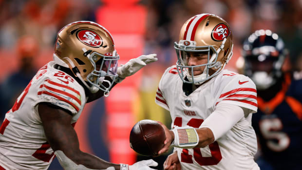 Sep 25, 2022; Denver, Colorado, USA; San Francisco 49ers quarterback Jimmy Garoppolo (10) hands the ball off to running back Jeff Wilson Jr. (22) in the third quarter against the Denver Broncos at Empower Field at Mile High.
