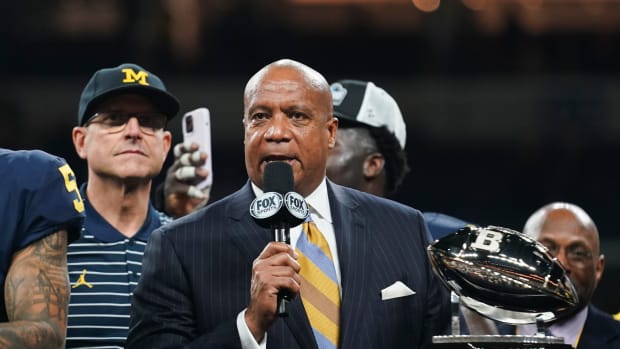 Dec 3, 2022; Indianapolis, Indiana, USA; Big Ten Commissioner Kevin Warren presents the championship trophy to Michigan Wolverines head coach Jim Harbaugh following their 43-22 victory against Purdue in the Big Ten Championship at Lucas Oil Stadium.