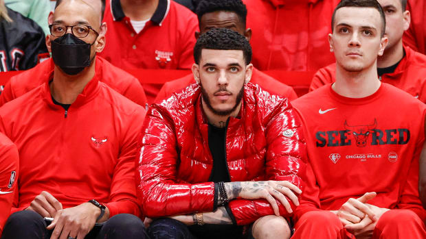 Apr 22, 2022; Chicago, Illinois, USA; Chicago Bulls guard Lonzo Ball (center) looks on from the bench during the second half of game three of the first round for the 2022 NBA playoffs against the Milwaukee Bucks at United Center.