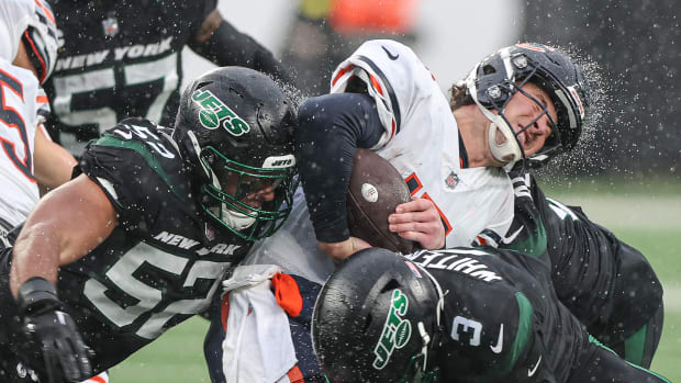 Nov 27, 2022; East Rutherford, New Jersey, USA; Chicago Bears quarterback Trevor Siemian (15) is tackled by New York Jets wide receiver Tarik Black (3) and defensive end Jermaine Johnson (52) during the first half at MetLife Stadium.