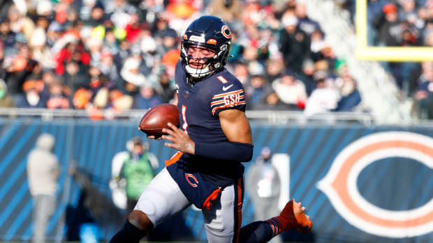 Dec 18, 2022; Chicago, Illinois, USA; Chicago Bears quarterback Justin Fields (1) rushes the ball against the Philadelphia Eagles during the second quarter at Soldier Field.