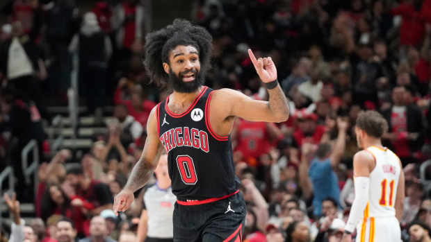 Apr 17, 2024; Chicago, Illinois, USA; Chicago Bulls guard Coby White (0) gestures after making a three point basket against the Atlanta Hawks during the second half during a play-in game of the 2024 NBA playoffs at United Center.