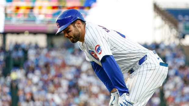 Jun 17, 2024; Chicago, Illinois, USA; Chicago Cubs outfielder Mike Tauchman (40) reacts after injuring his leg after running to first base after hitting a single against the San Francisco Giants during the third inning at Wrigley Field.