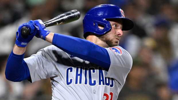 Apr 9, 2024; San Diego, California, USA; Chicago Cubs first baseman Michael Busch (29) hits a single against the San Diego Padres during the fourth inning at Petco Park.